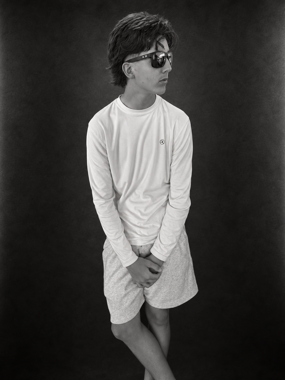 Boston Healy in sunglasses and a white long-sleeve shirt