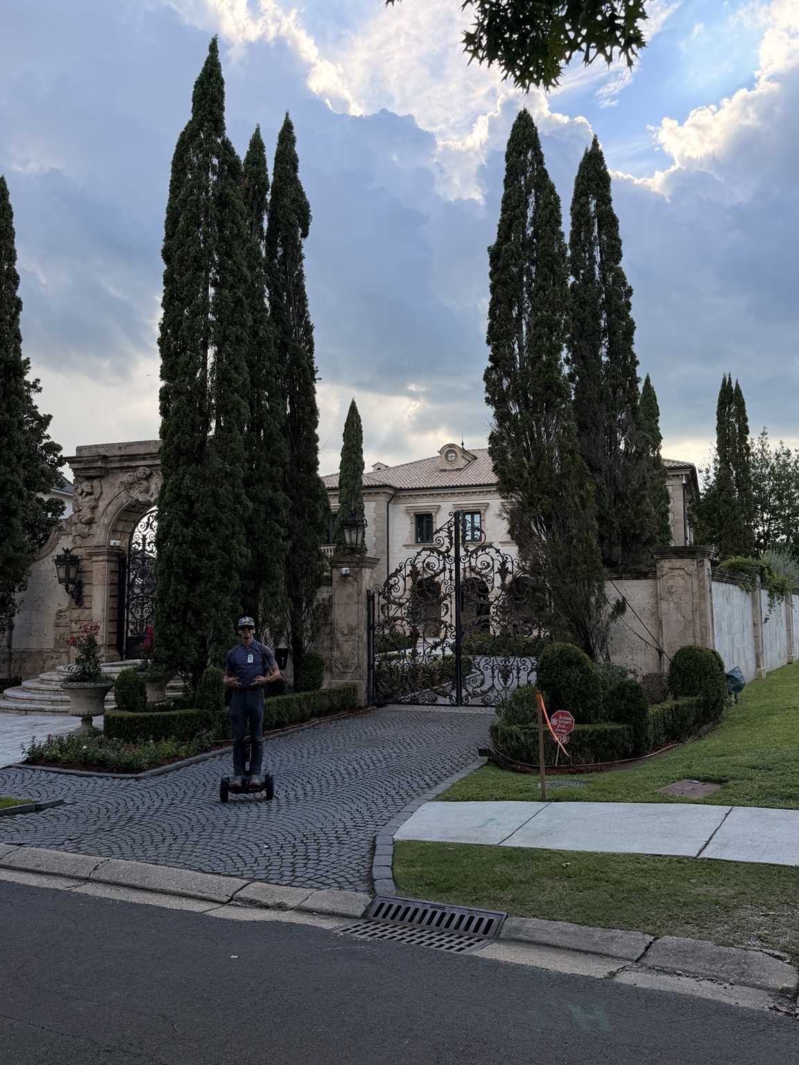 A sales representative working outside a large home